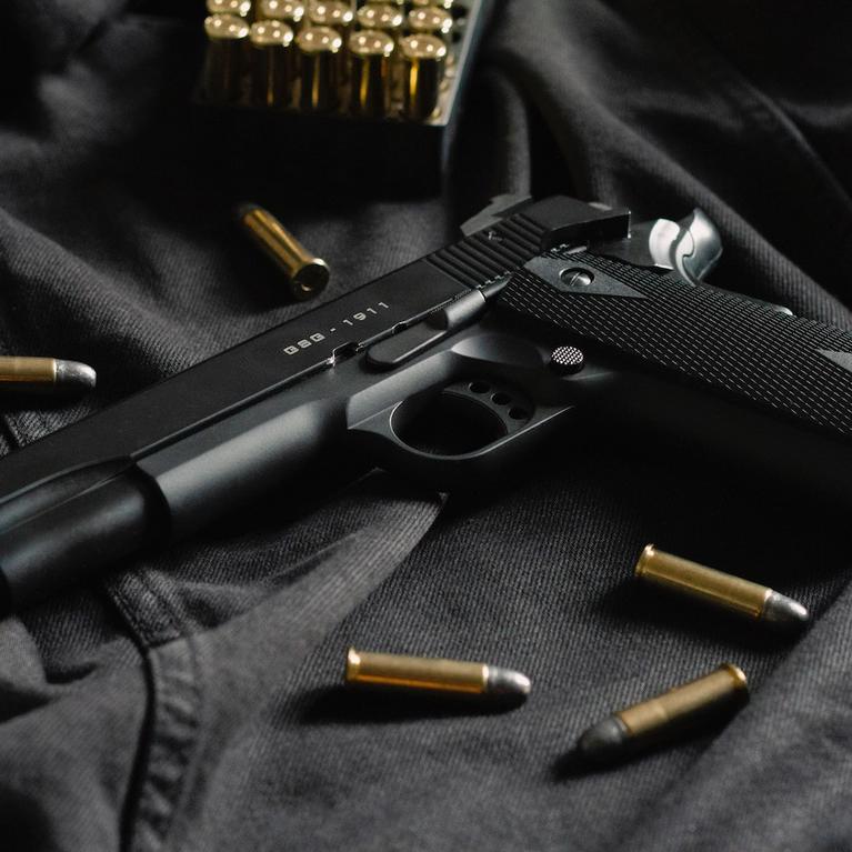 A handgun with bullets by Thomas Def